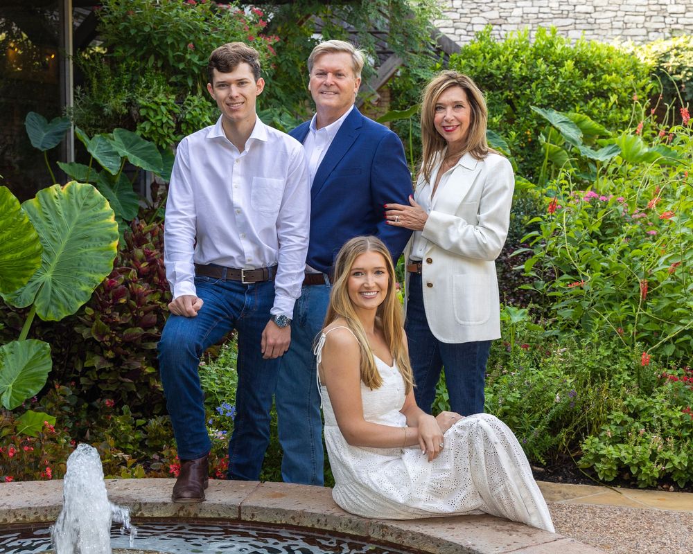 happy family of four next to a fountain