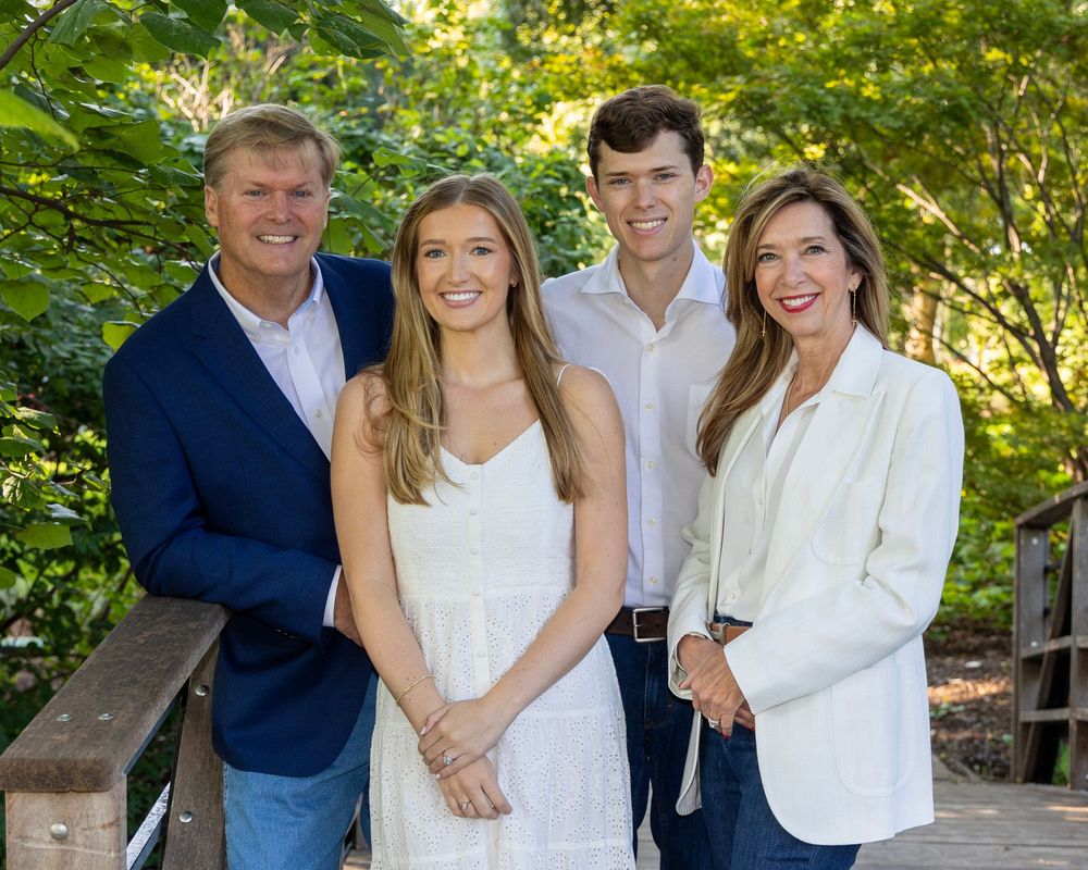 Happy family of four on a bridge