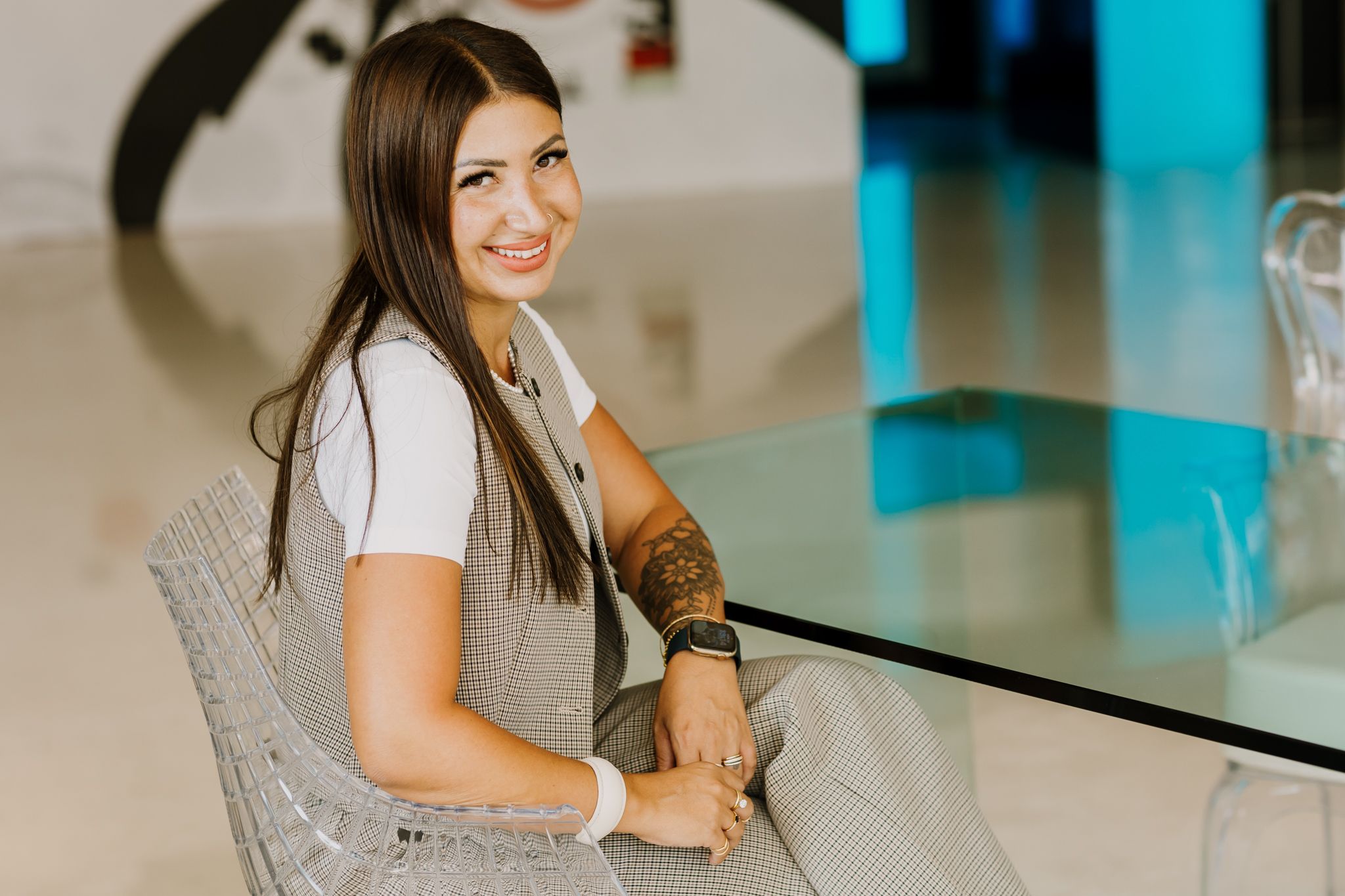 Business woman is sitting near a table in a personal brand photoshoot.