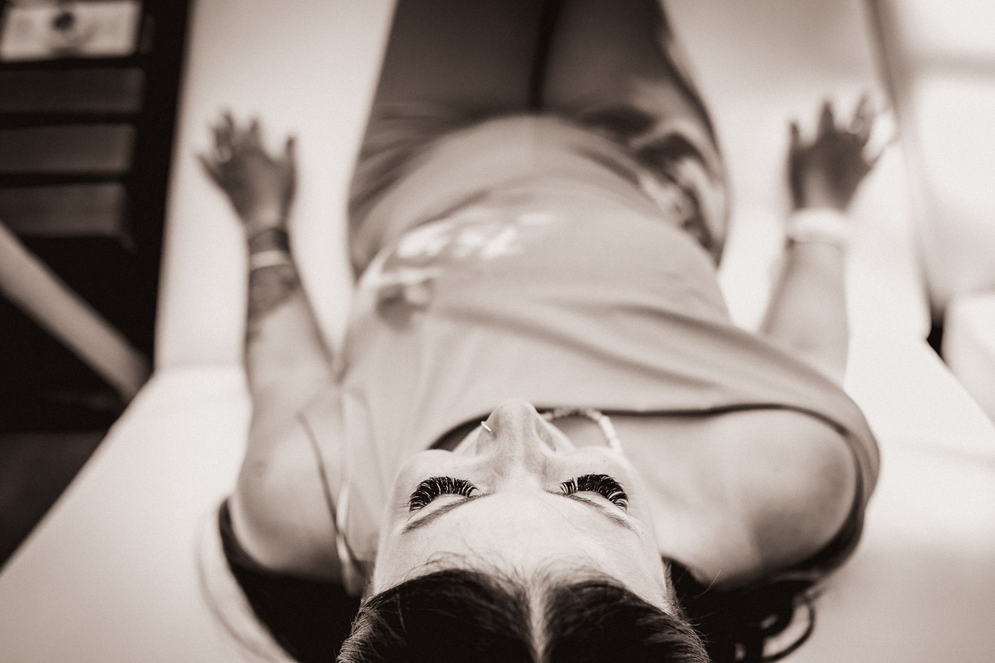 Photo taken from above of a woman sitting on a beach chair.
