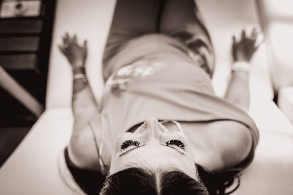 Photo taken from above of a woman sitting on a beach chair.