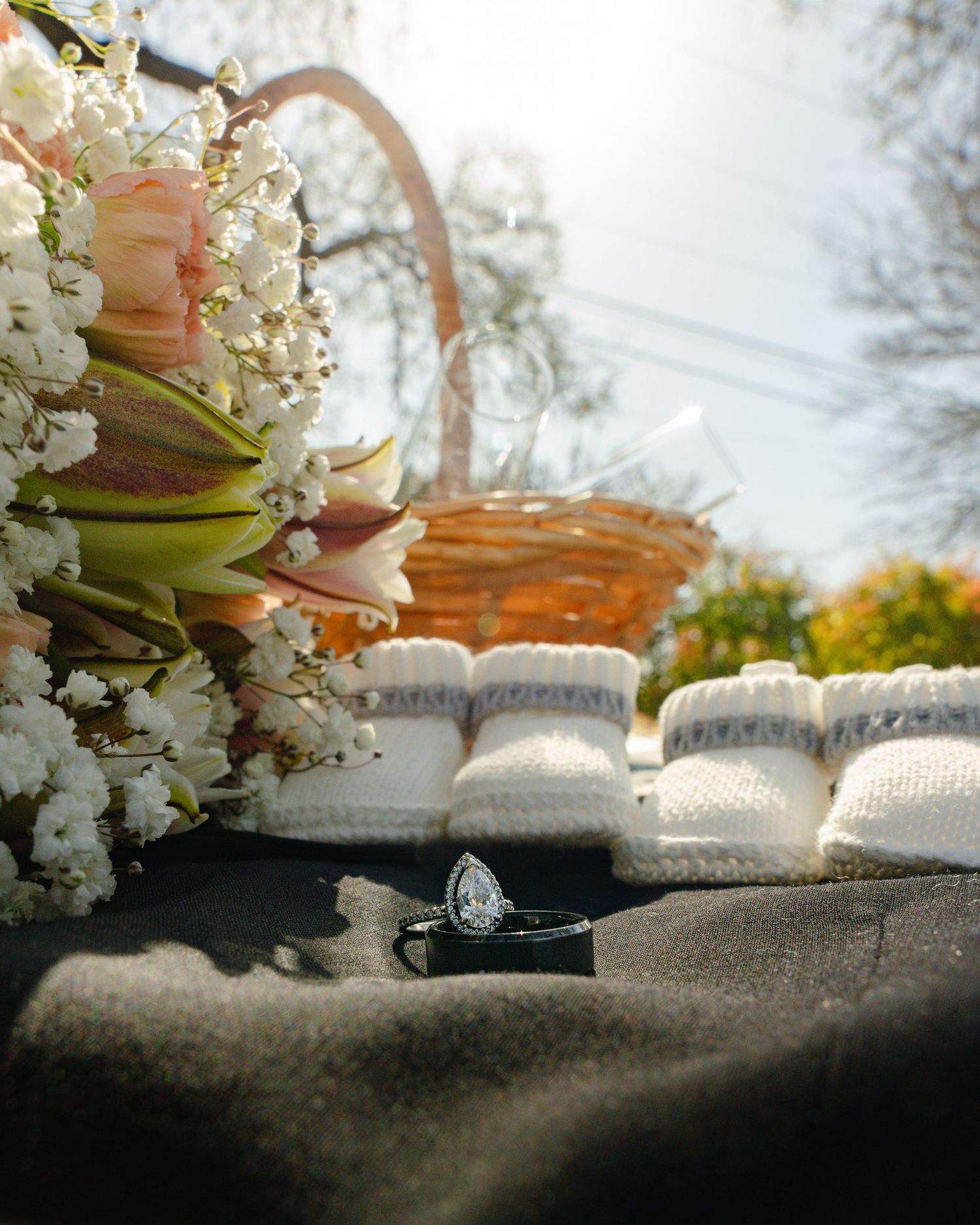 White baby's breath flowers and ultrasound photos arranged on a textured surface in natural light.