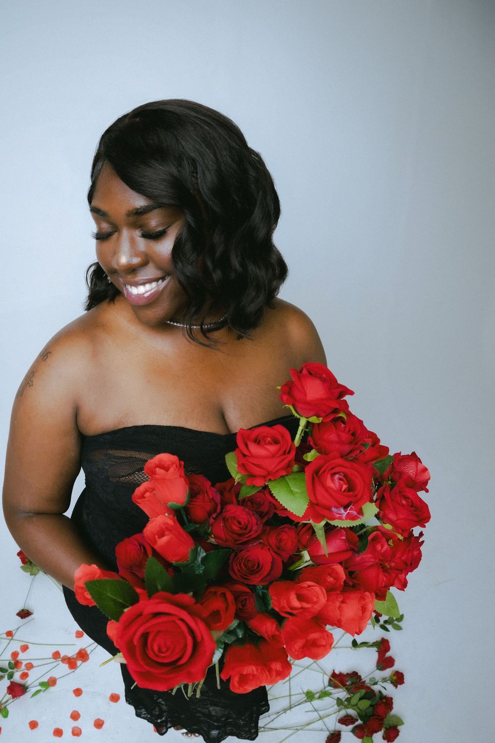 A series of elegant portraits featuring vibrant red roses against a black background.