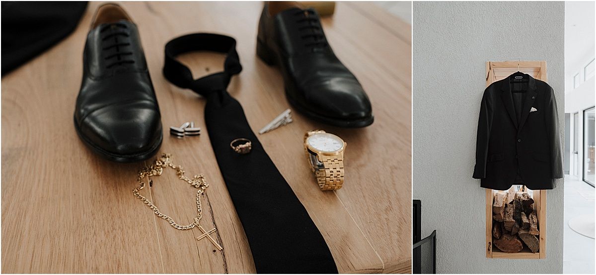 Collection of elegant black leather dress shoes and accessories arranged on wooden surface.
