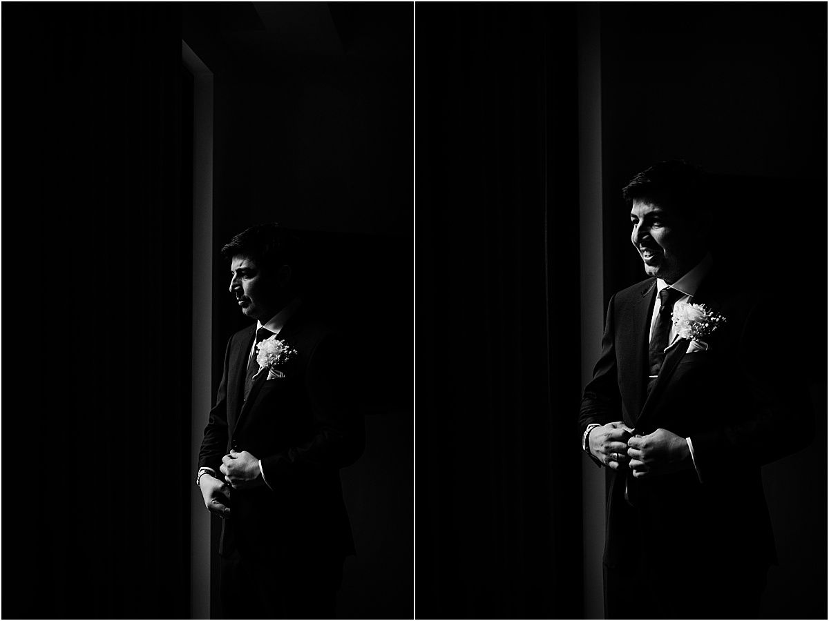 Dramatic black and white portraits of groomsmen in formal attire standing in shadowy doorways.