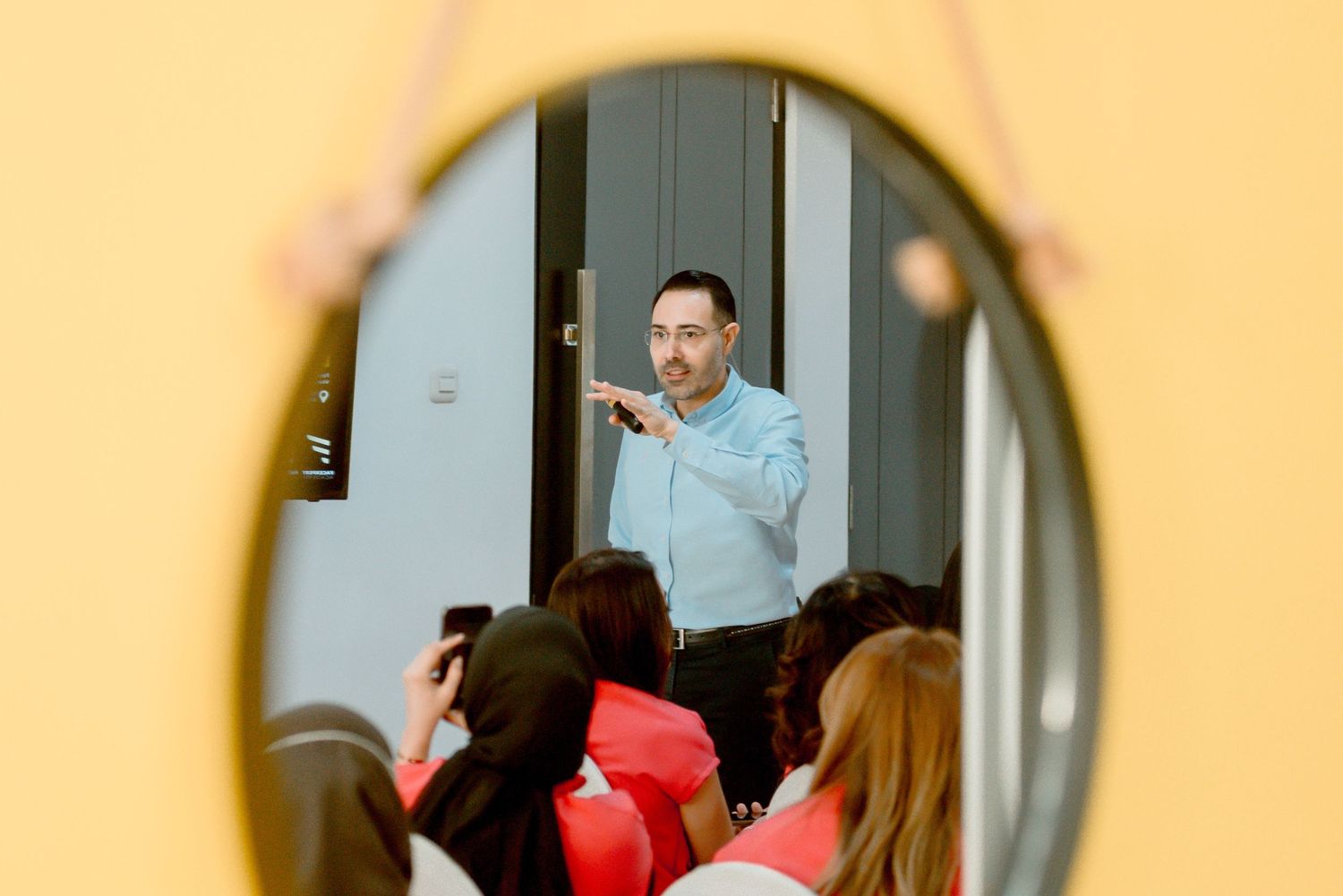 A series of four connected photos showing someone opening a door and walking through it in a bright interior space.