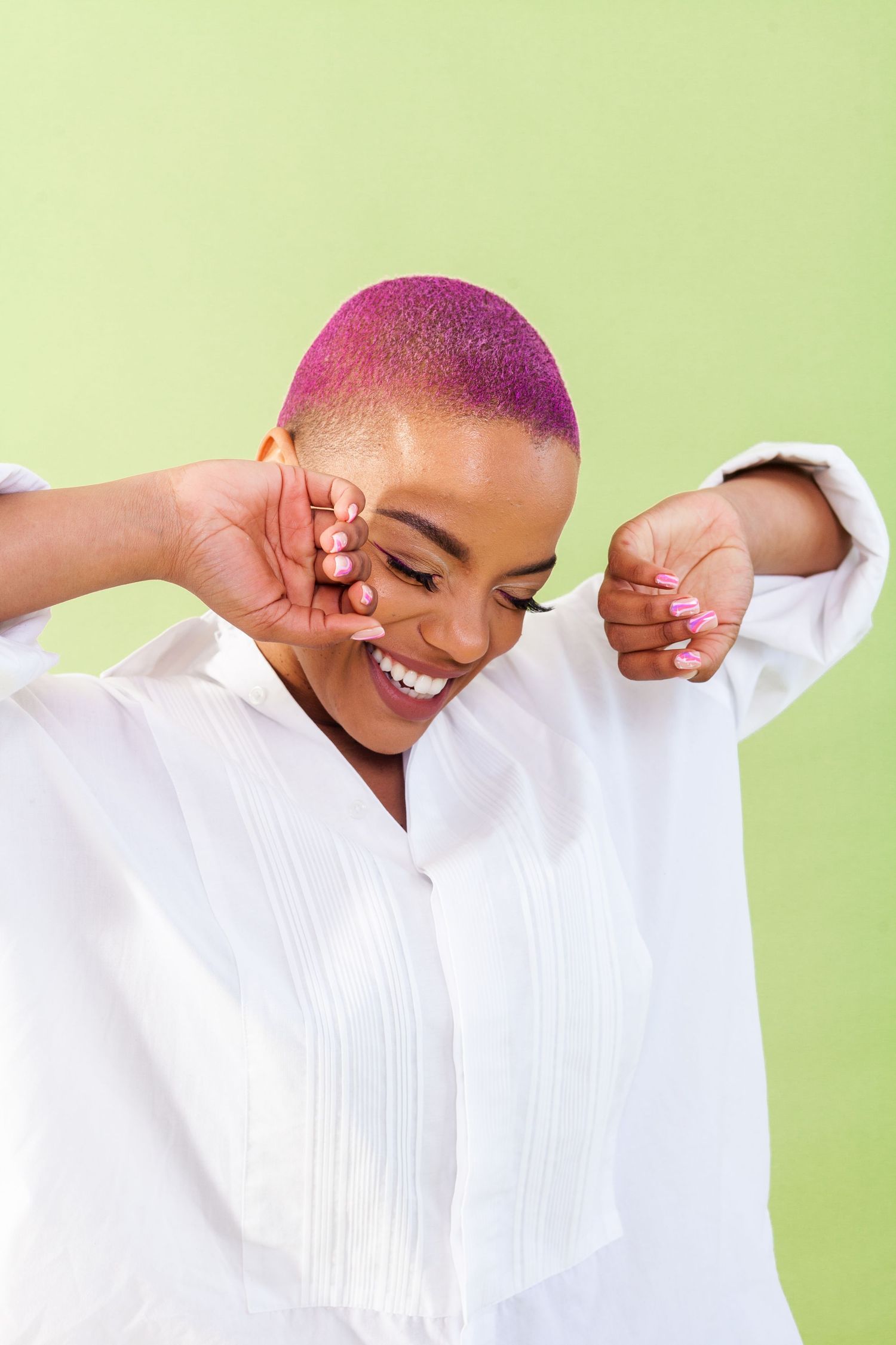 Candid moments showing genuine smiles in a crisp white shirt against mint green backdrop.