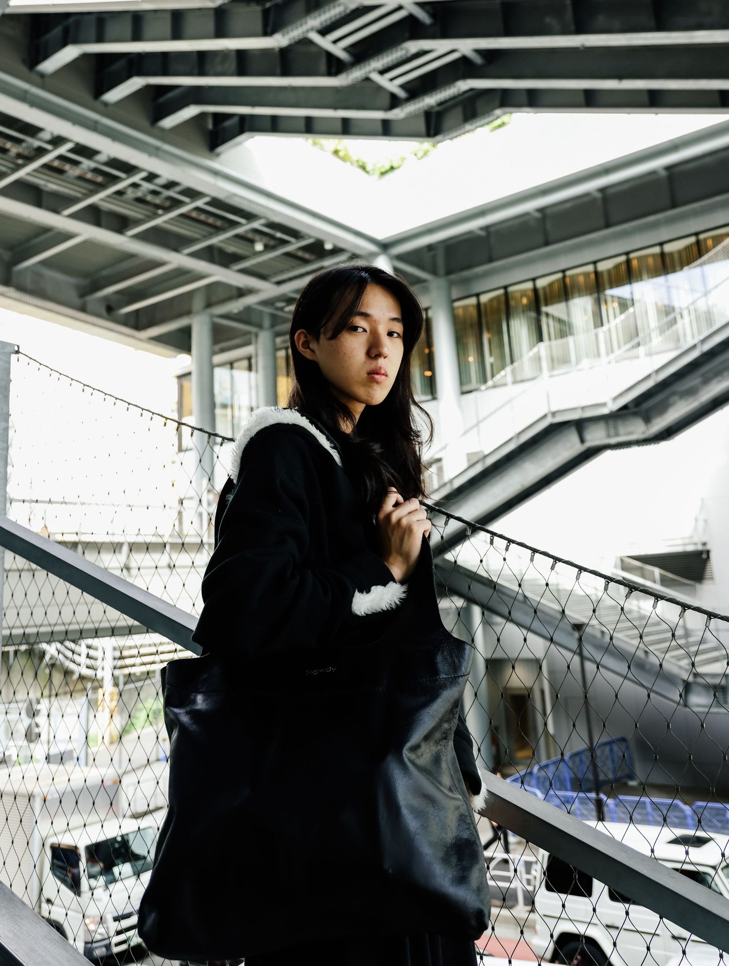 Urban photography series in black outfit against modern architectural background.