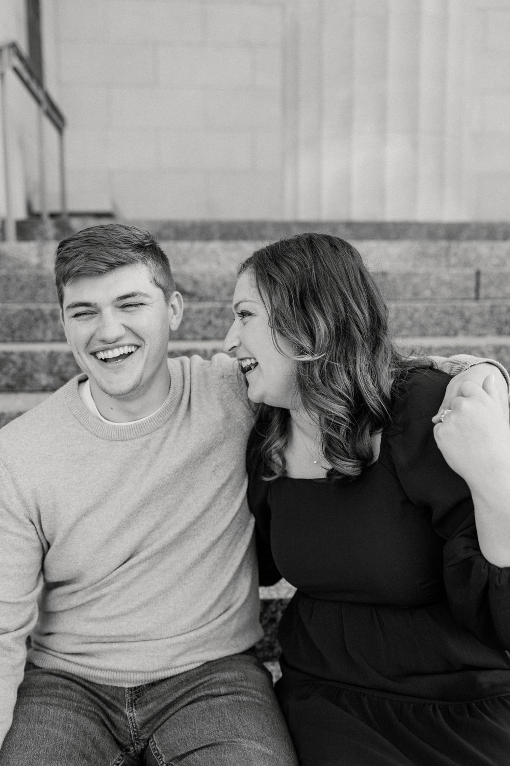 A candid black and white photo series captures a couple laughing together.