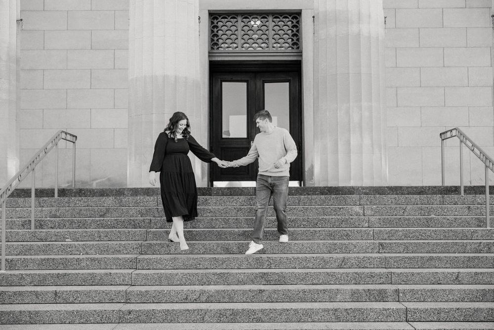 A black and white photo of people on wide stone steps of a building.