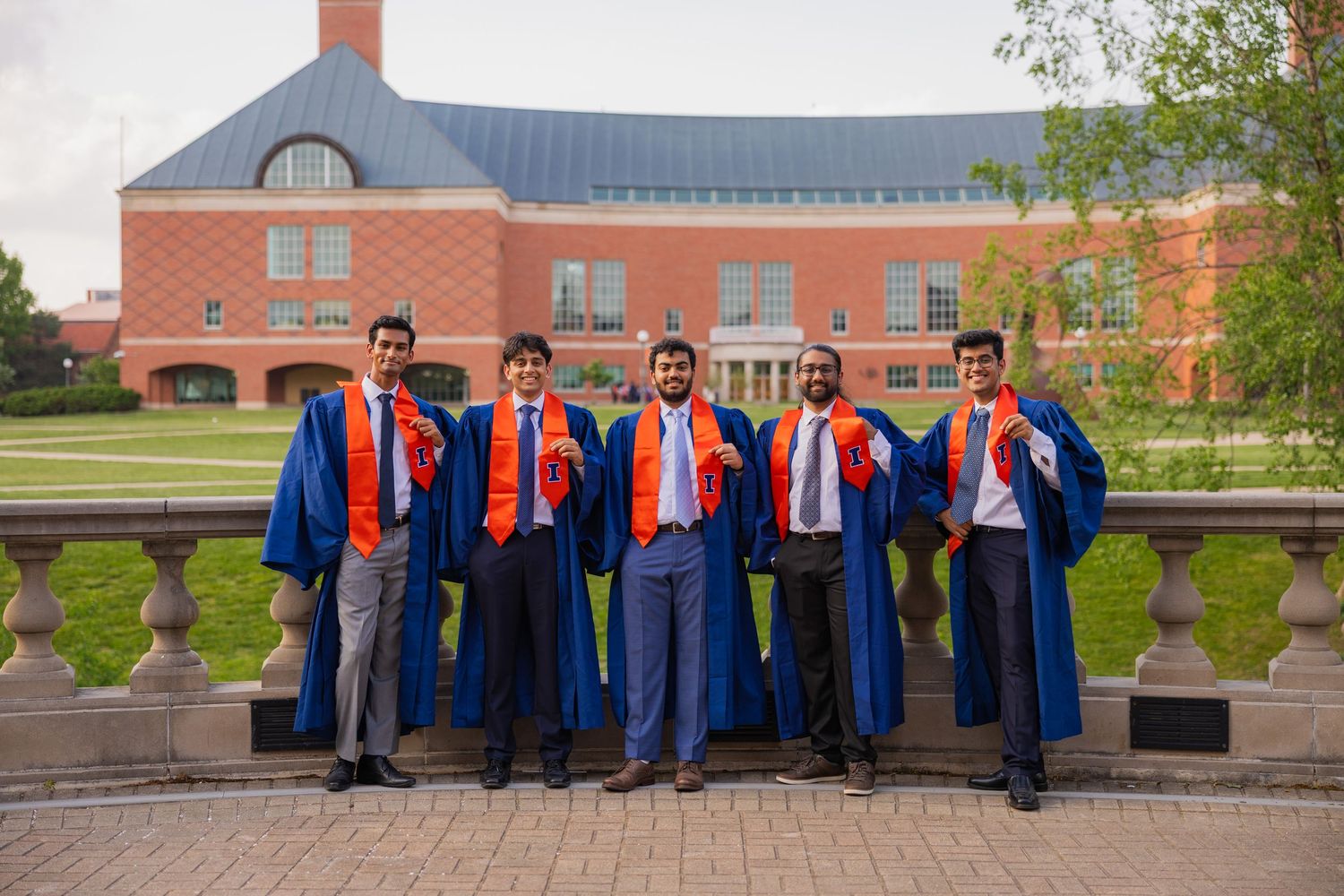 Group of UIUC engineering students celebrate graduation at the Engineer Quad