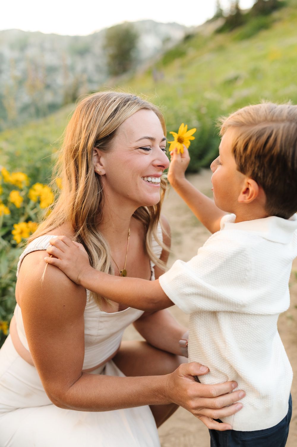 Tender moments captured against a backdrop of mountain wildflowers during golden hour.