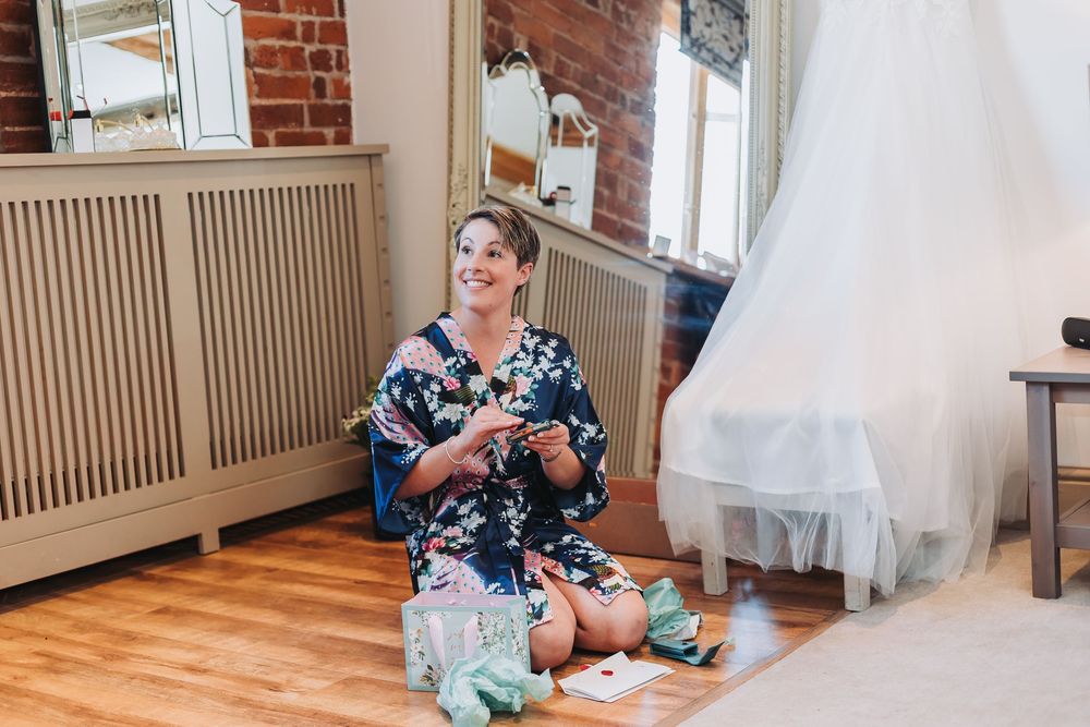 Interior room with hardwood floors, exposed brick walls and radiator showing wedding preparations.