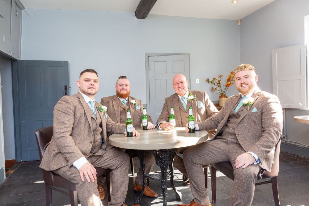 Wedding party gathering in a modern reception venue with gray walls and minimalist decor.