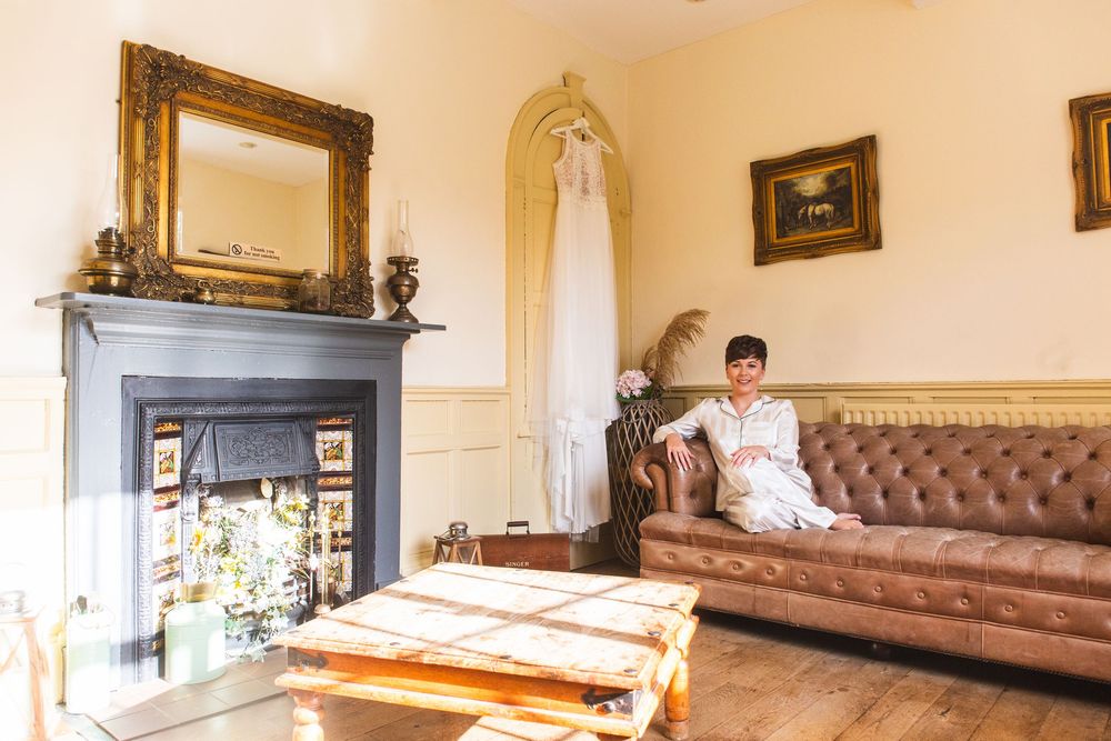 Interior view of an elegant room with cream walls, leather furniture and ornate gold-framed artwork.