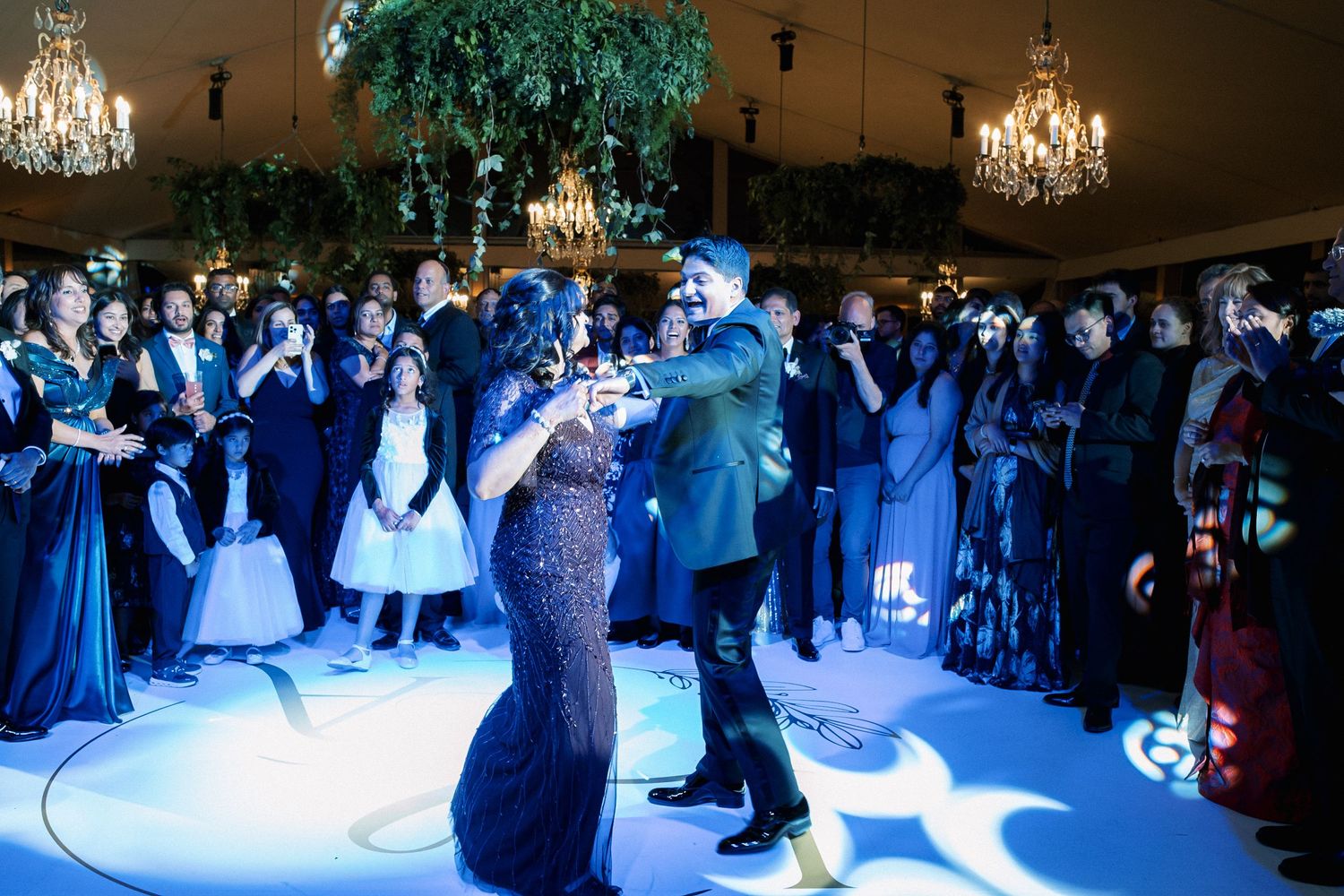 Groom dancing with his mother during luxury Indian wedding reception in Portugal