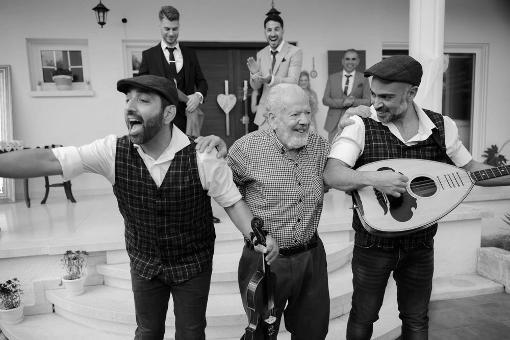 Black and white photo montage showing candid moments of musicians performing and interacting backstage.