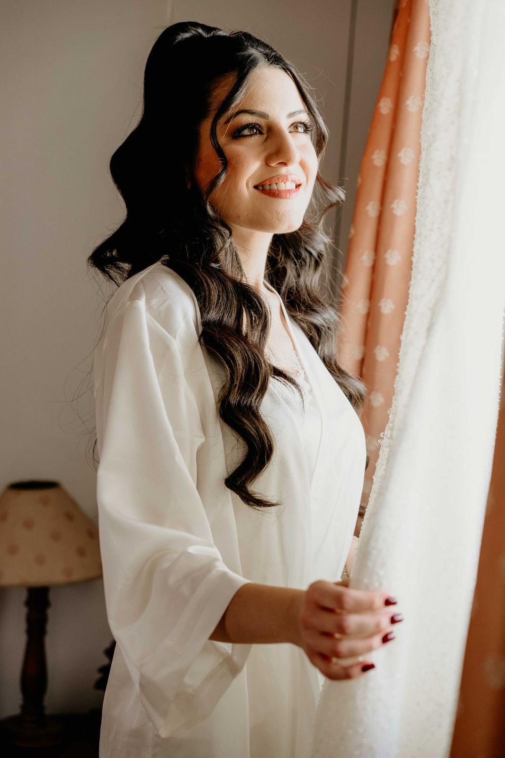 A series of intimate portrait photos showing someone in a white robe by a window with soft natural lighting.