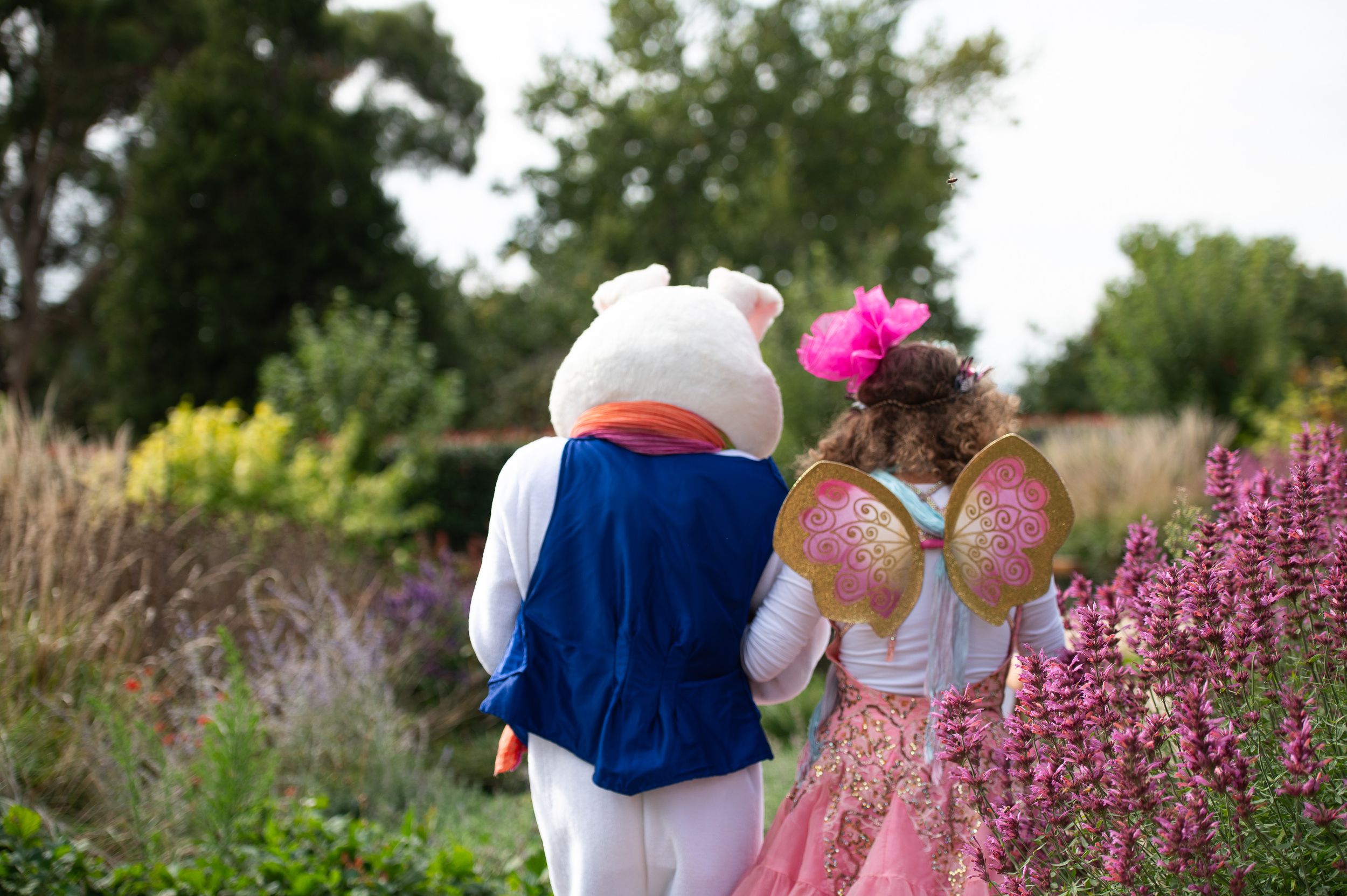 Easter bunny and fairy walking from behind