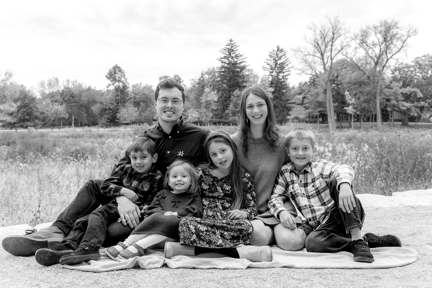 Family portrait series showing joyful moments together on outdoor steps.
