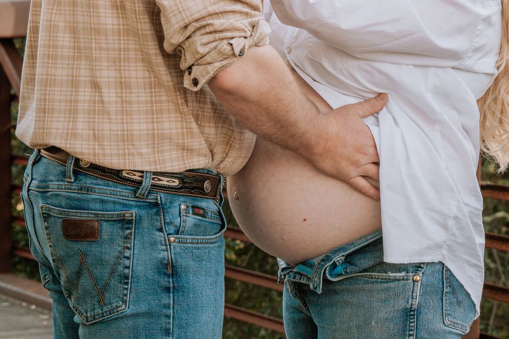 Close-up photos showing a pregnant belly in plaid shirt and jeans at different angles and stages of pregnancy.