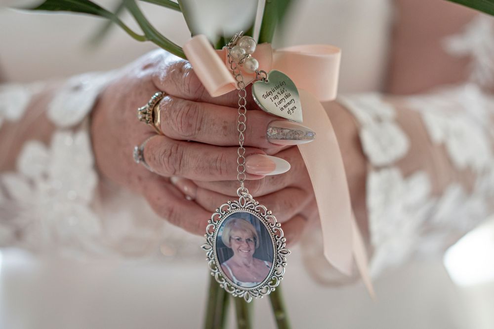 Close-up of hands holding delicate vintage-style jewelry and lockets with ornate details.