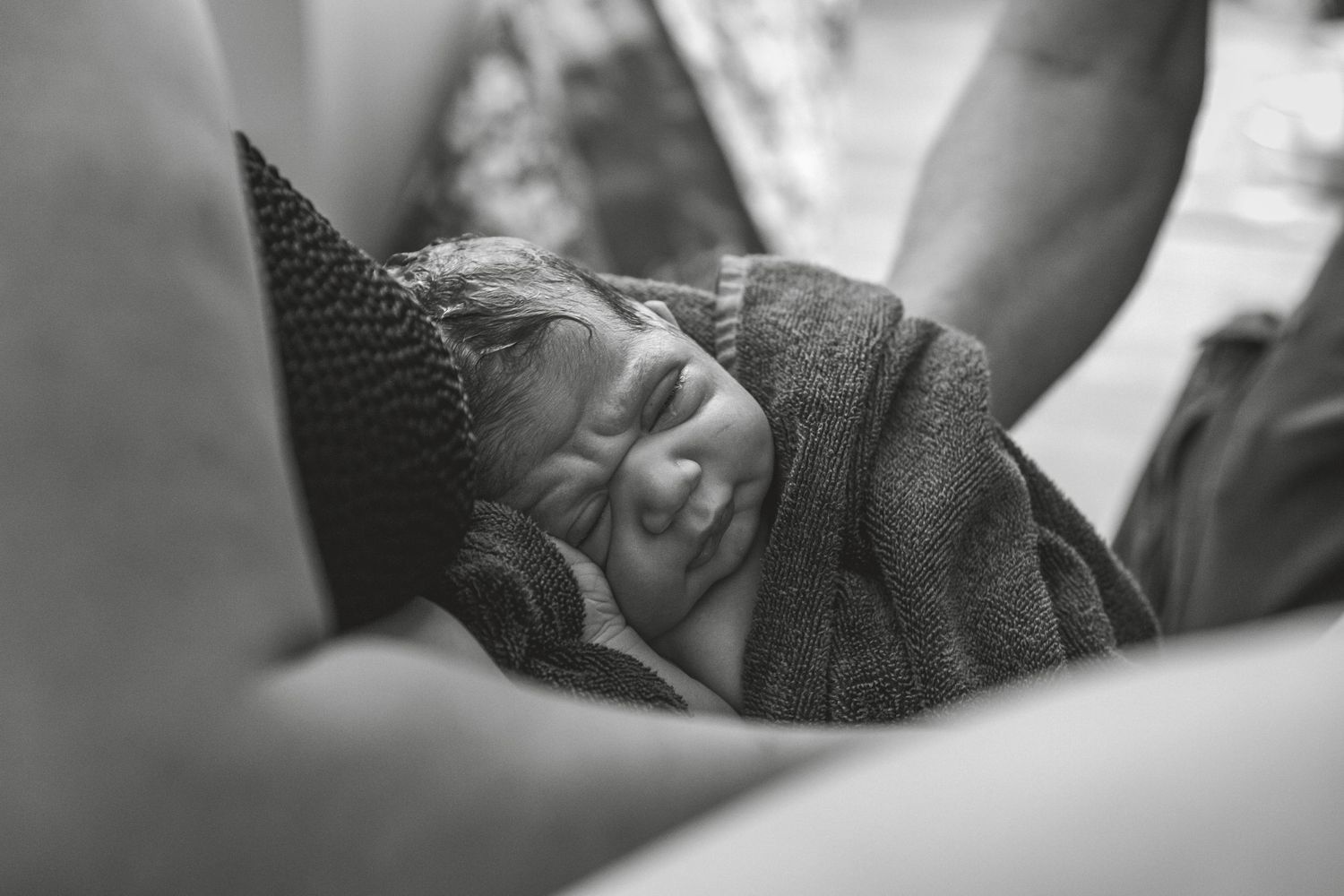 A series of black and white photos showing tender moments between a couple in intimate poses.