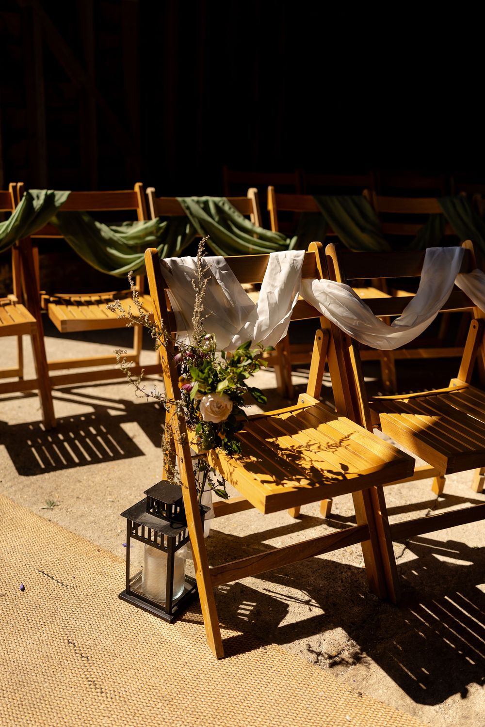 Wooden deck chairs casting dramatic shadows in sunlight with decorative elements.