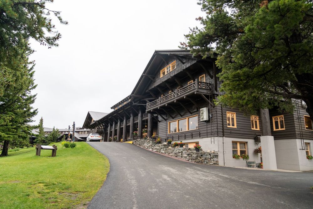 A series of connected exterior photos showing a rustic mountain lodge with stone walls and wooden architecture.