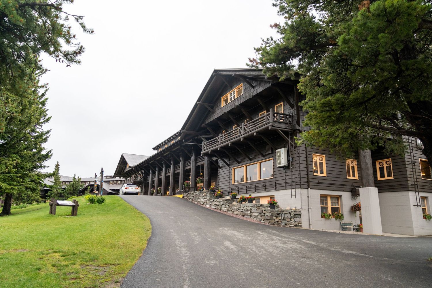A series of connected exterior photos showing a rustic mountain lodge with stone walls and wooden architecture.