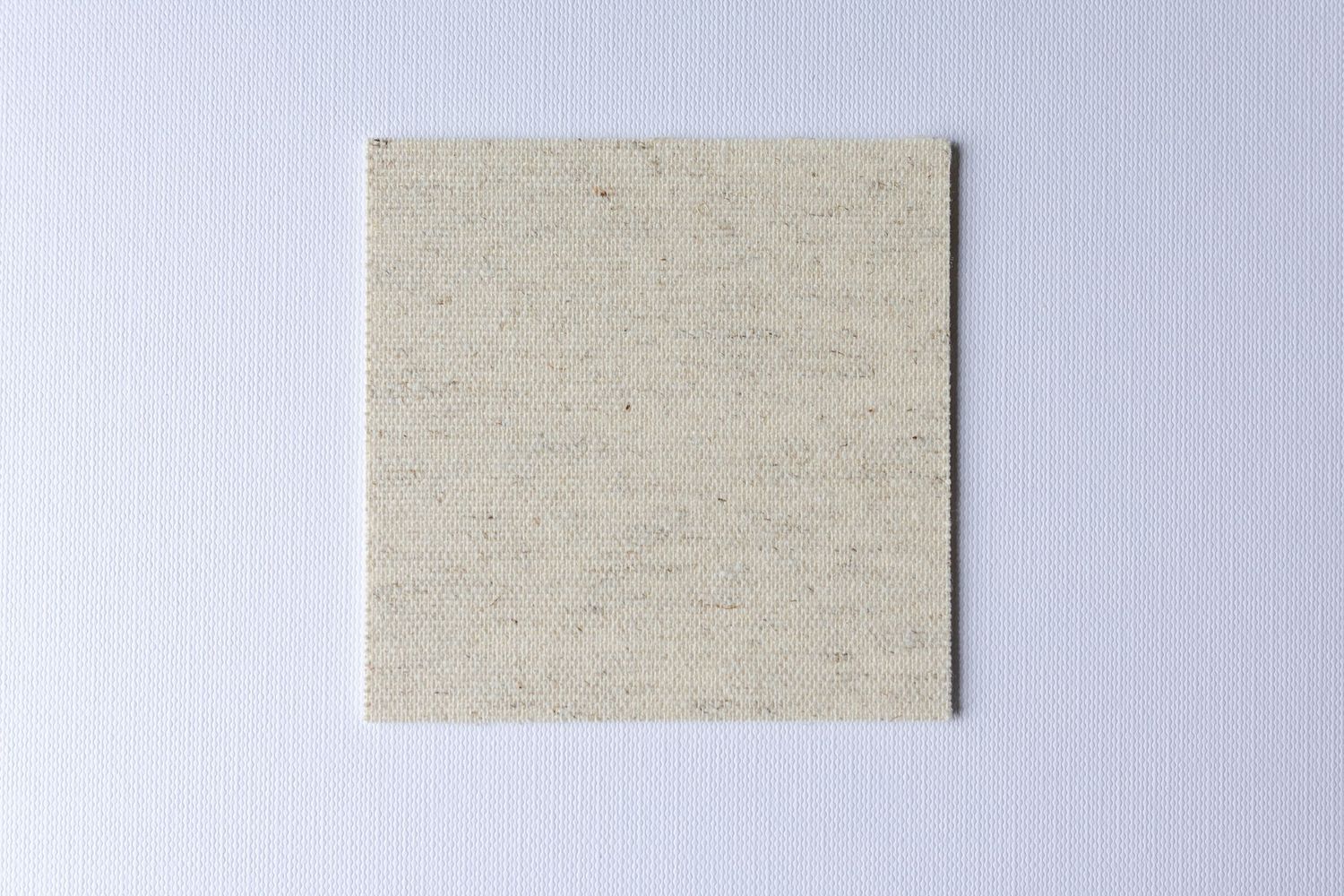 A row of five identical beige linen or canvas textured paper samples arranged horizontally.