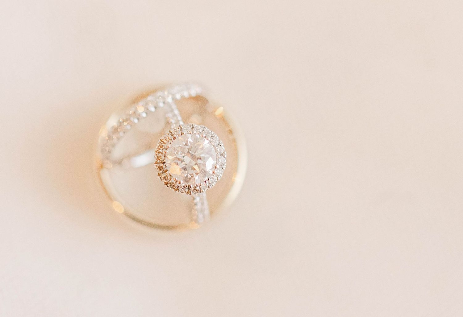 Six rose gold engagement rings with diamonds and intricate details shown in a row on a soft beige background.