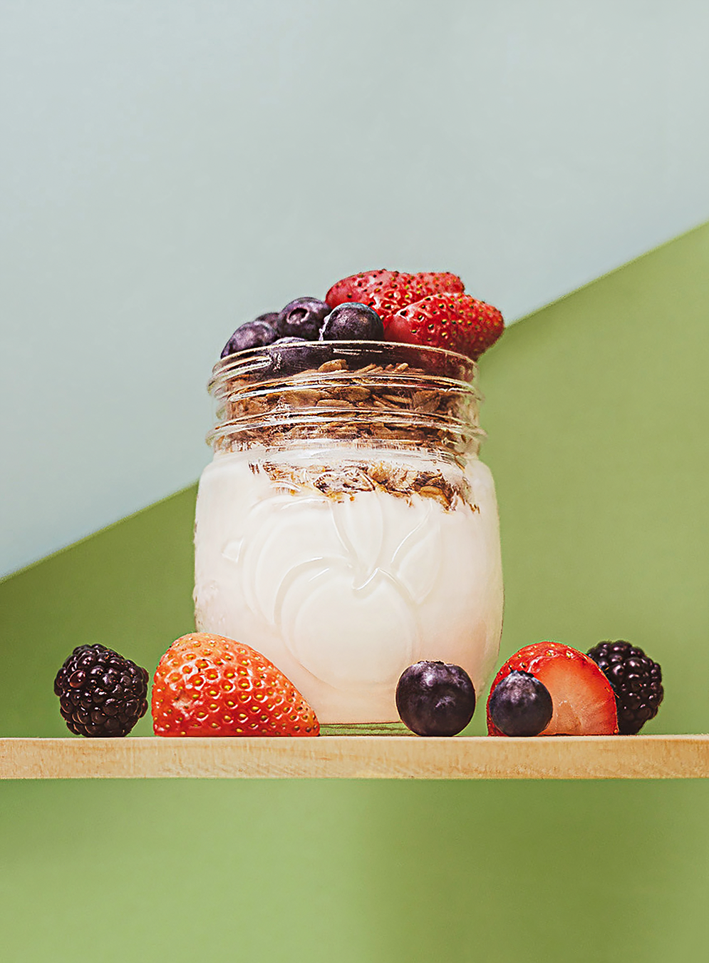 Product photography featuring berries in a glass jar, created by commercial photographer Chris Z of Zeng Studio.