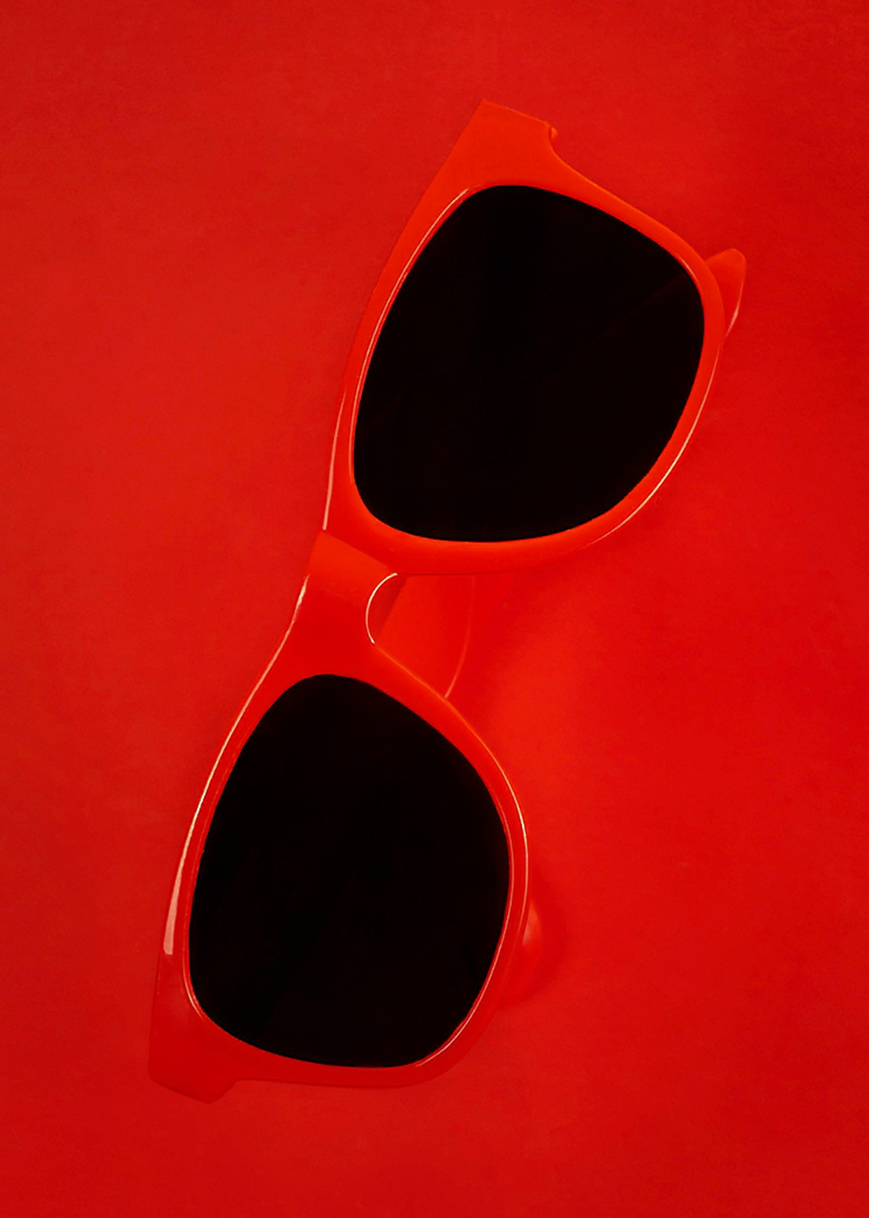 Product photography featuring a pair of red sunglasses, created by commercial photographer Chris Z of Zeng Studio.