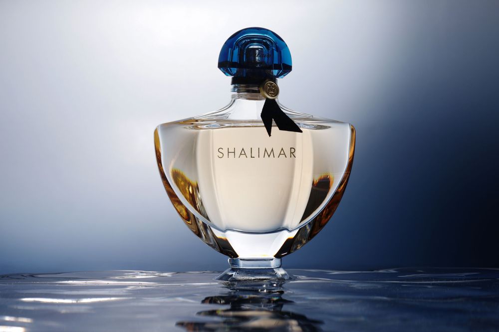 Studio product photography highlighting a luxury fragrance bottle and packaging.