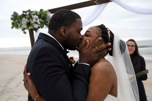 Intimate moment between newlyweds during their beach wedding ceremony.