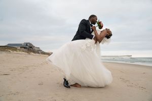 Newlyweds share intimate moments during their beach wedding photoshoot.