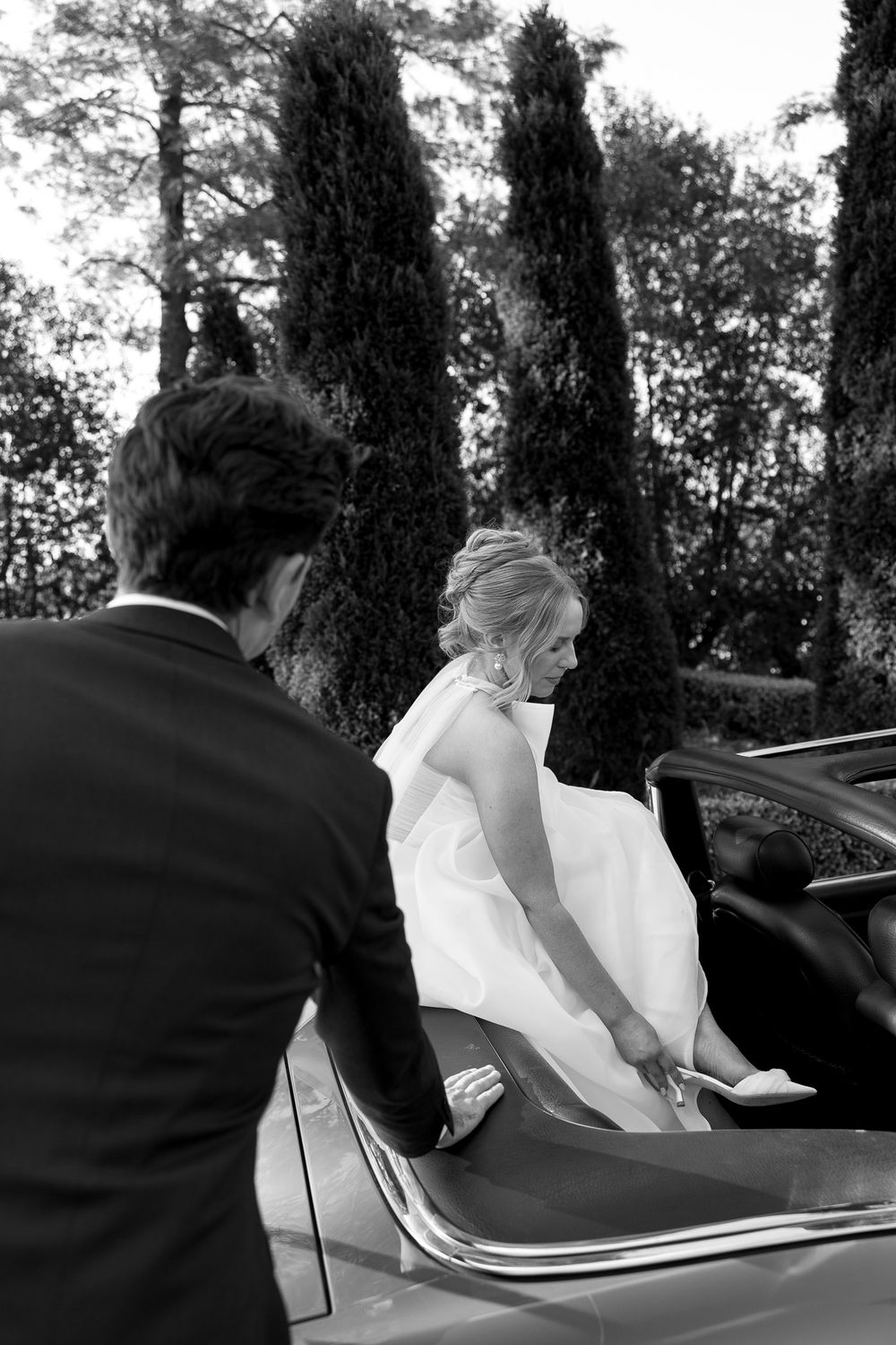 A sequence of photos showing a couple getting into a classic car after their wedding ceremony.