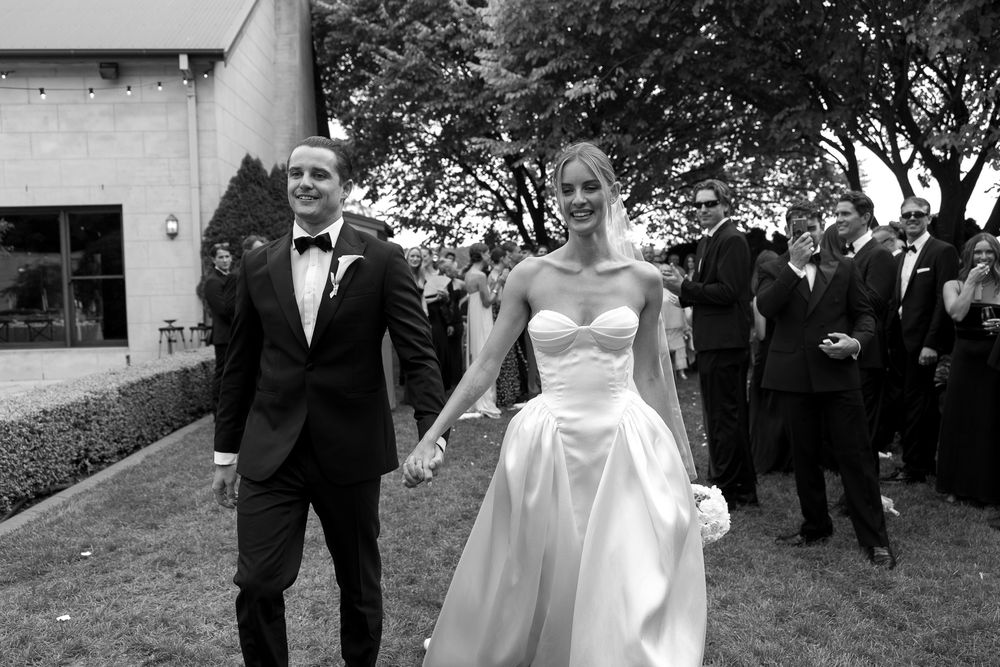 A collection of black and white wedding photos showing couples celebrating outdoors with guests and formal attire.