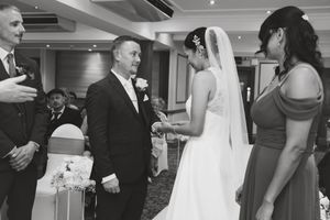 A sequence of black and white wedding reception photos showing dancing and celebration moments at an elegant venue.