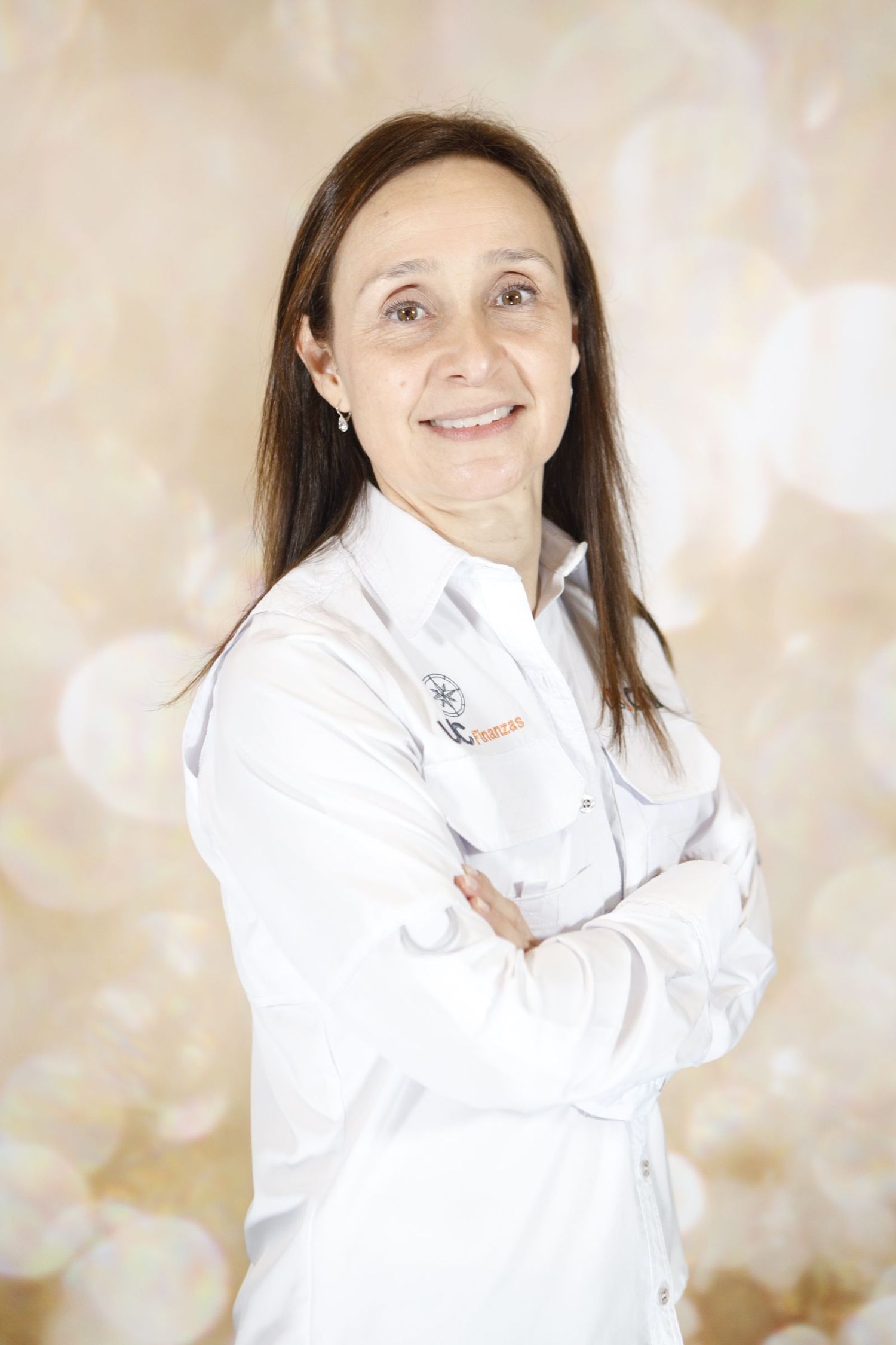 A person in a white collared shirt smiles warmly in a series of four connected professional headshot photos.