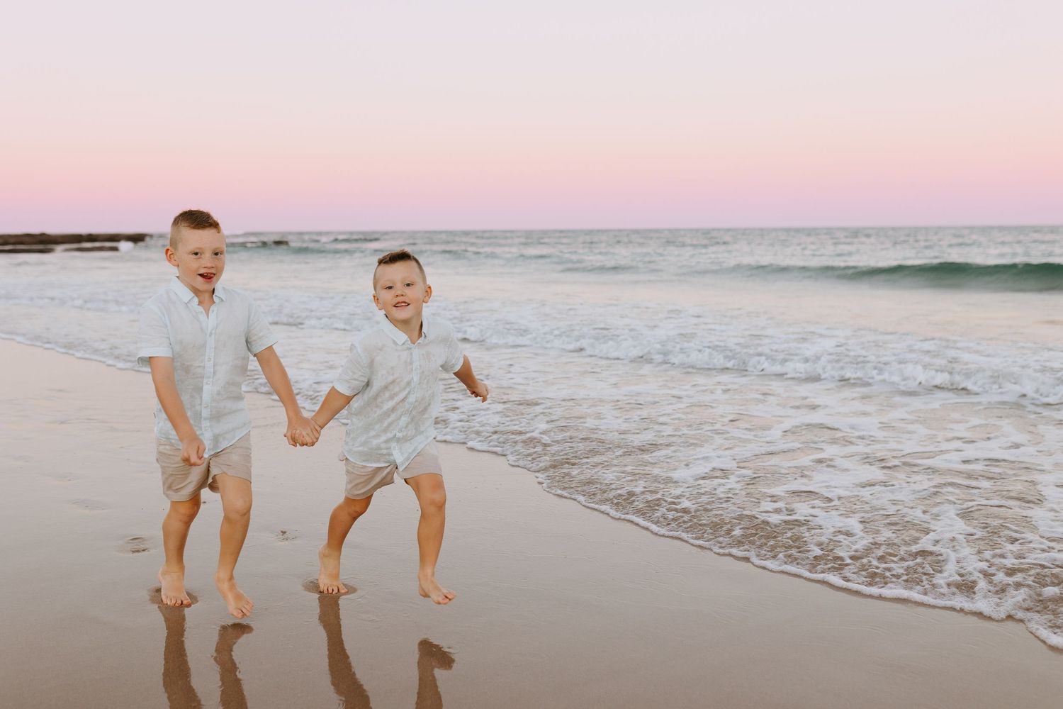 Sunset beachside portraits with barefoot family members.