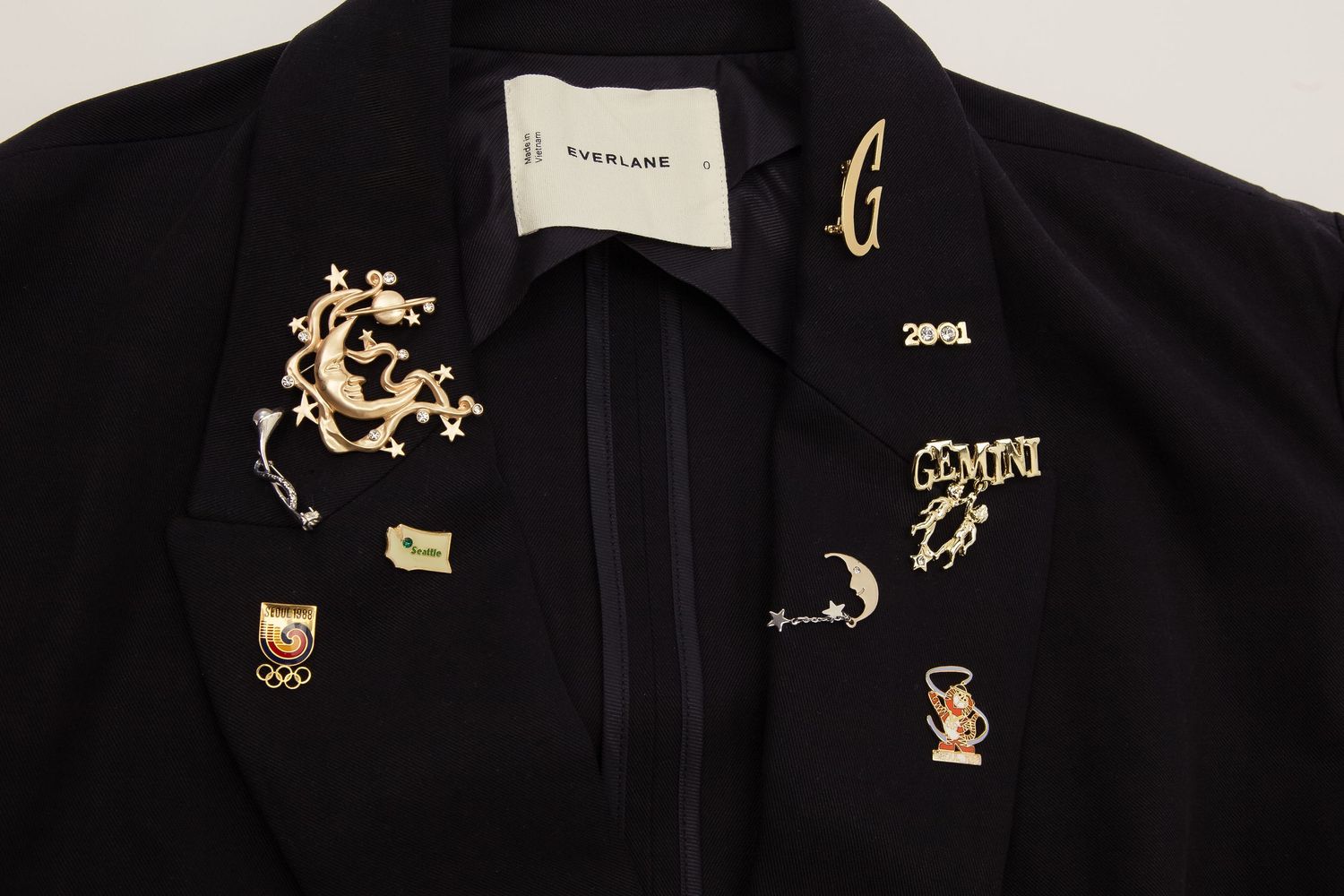 Close-up view of gold embroidered dragon designs on black fabric showing intricate Asian-inspired details.