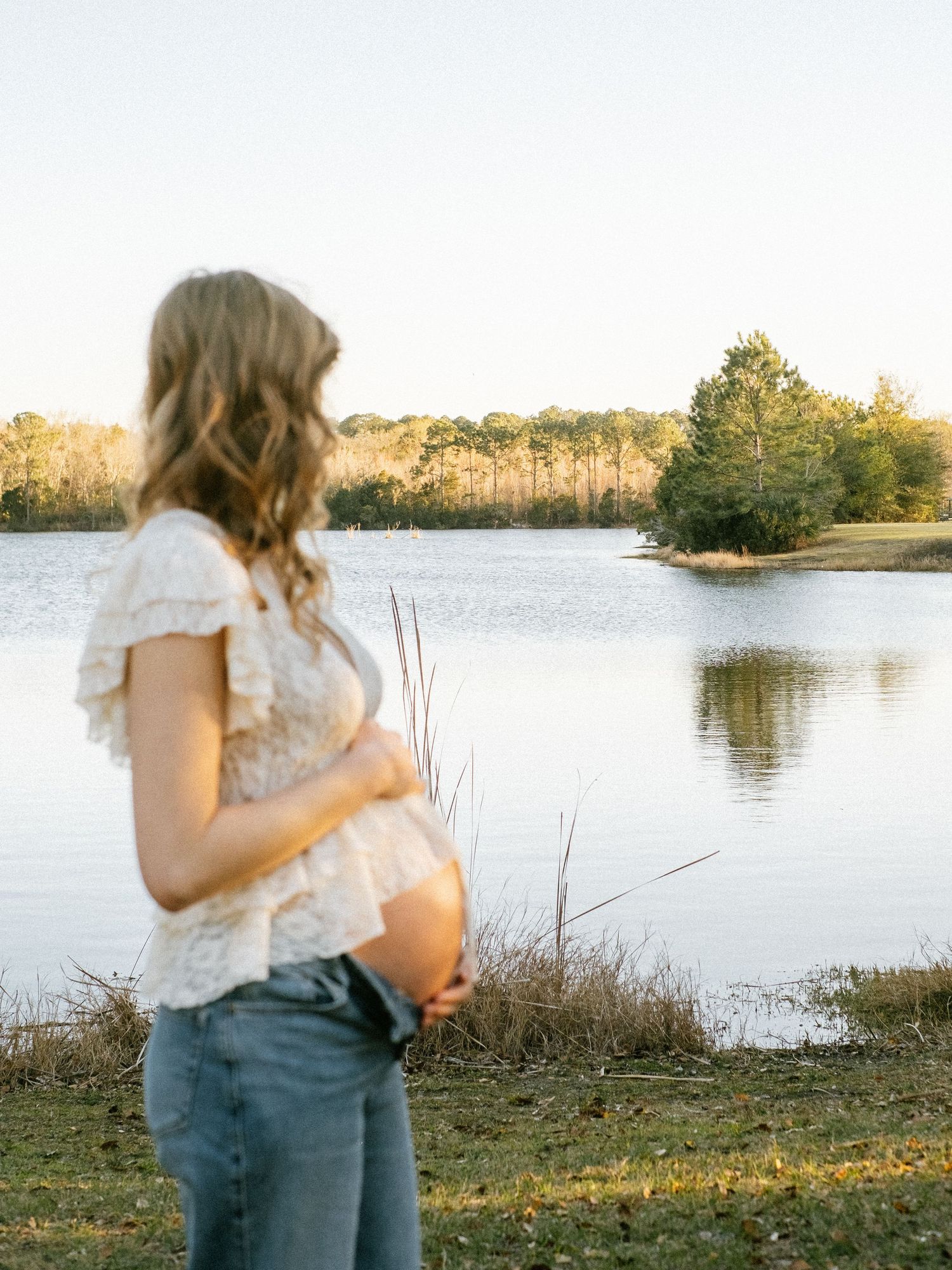 Couple maternity portraits under loblolly pine trees at William F. Sheffield Regional Park Jacksonville