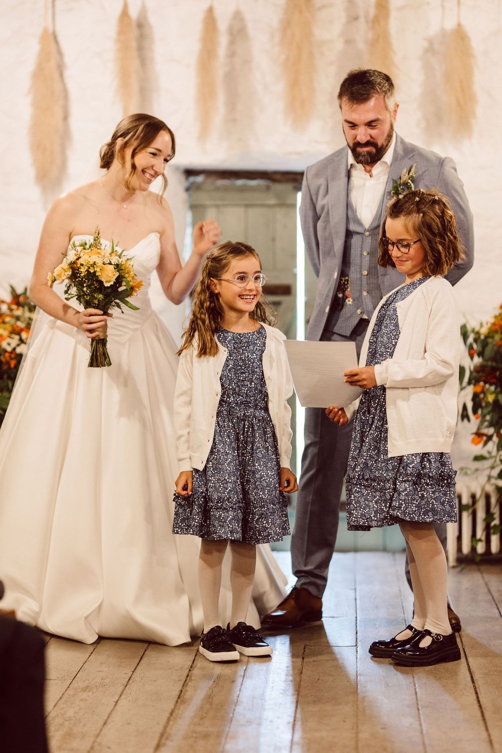 Heartwarming series of wedding photos showing sweet interactions between flower girl and wedding party members.