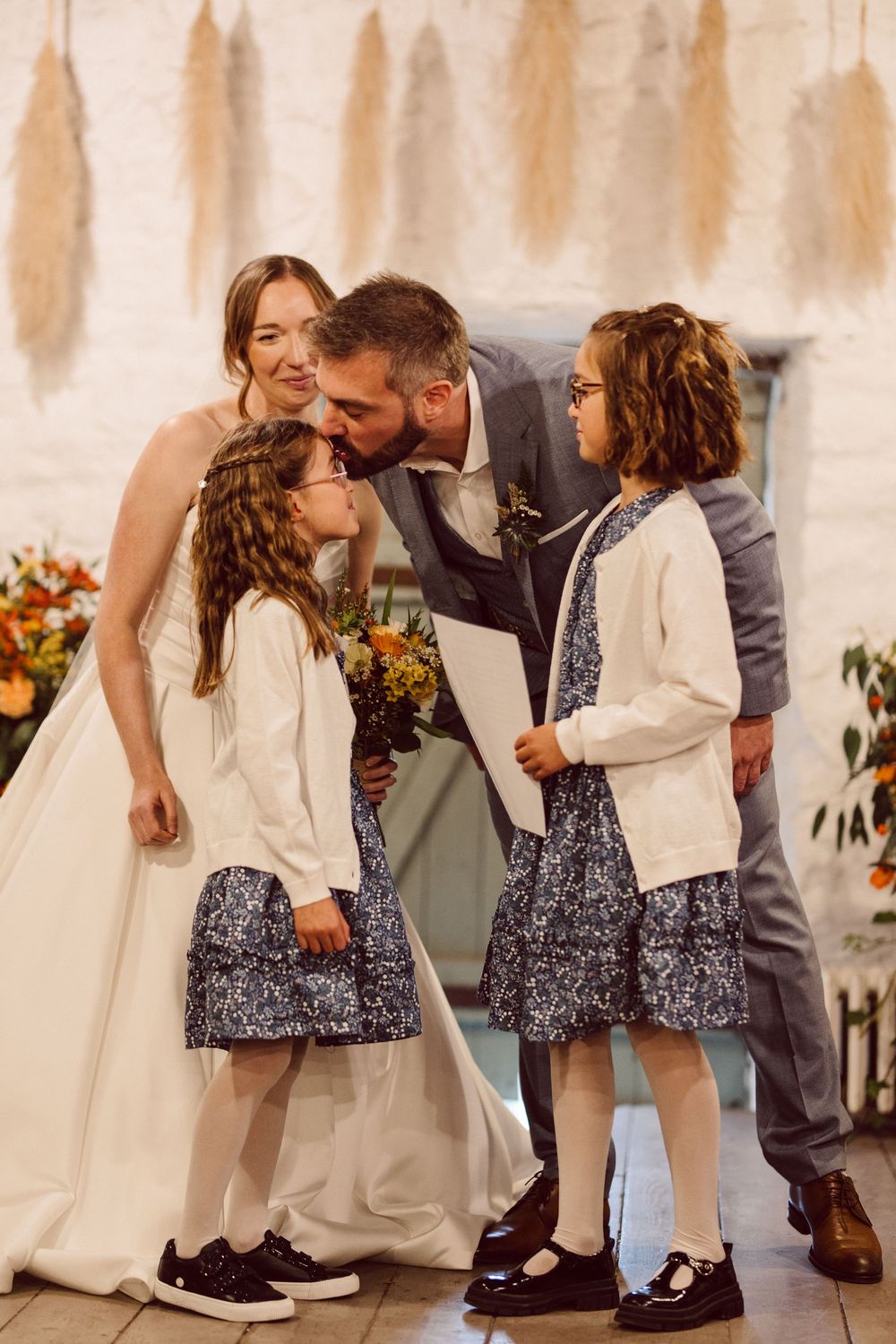 A sweet sequence of wedding moments showing a couple sharing tender interactions with a young flower girl in a white dress.