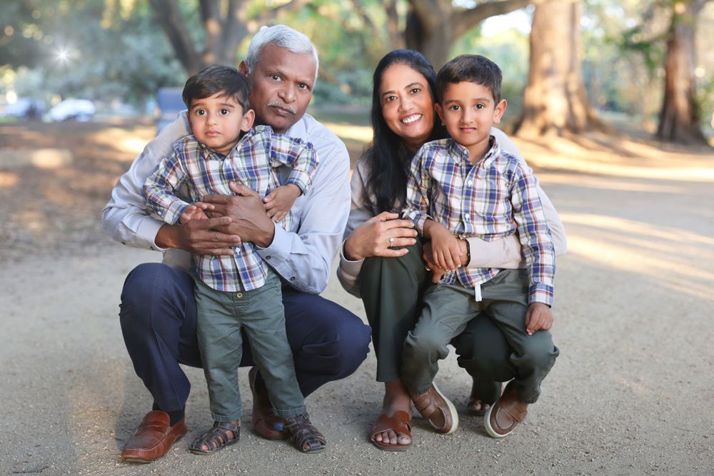A collage of outdoor family portraits showing people sitting together on the ground in casual clothing.