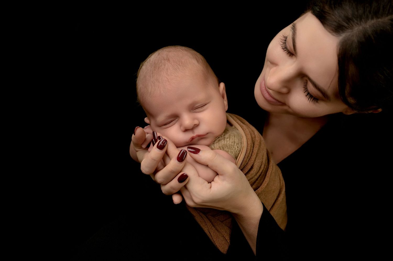 A tender moment between parent and baby shown in six connected black and white photographs.