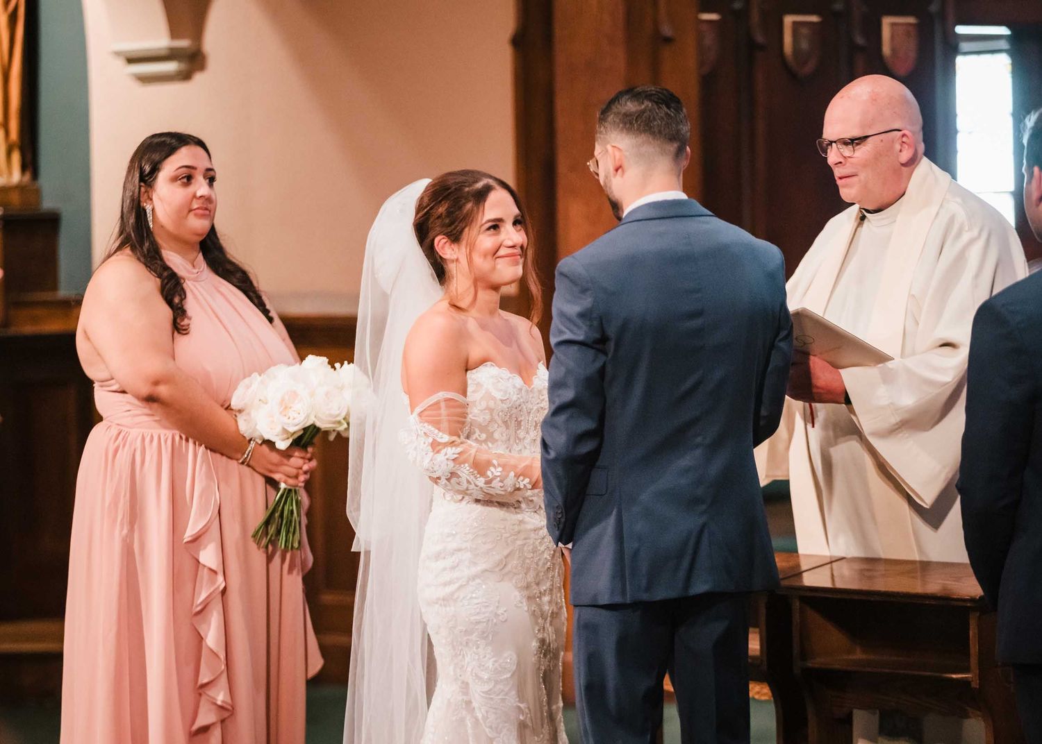 Bride and groom exchanging vows during Catholic wedding ceremony at Saint Brigid Church in South Boston