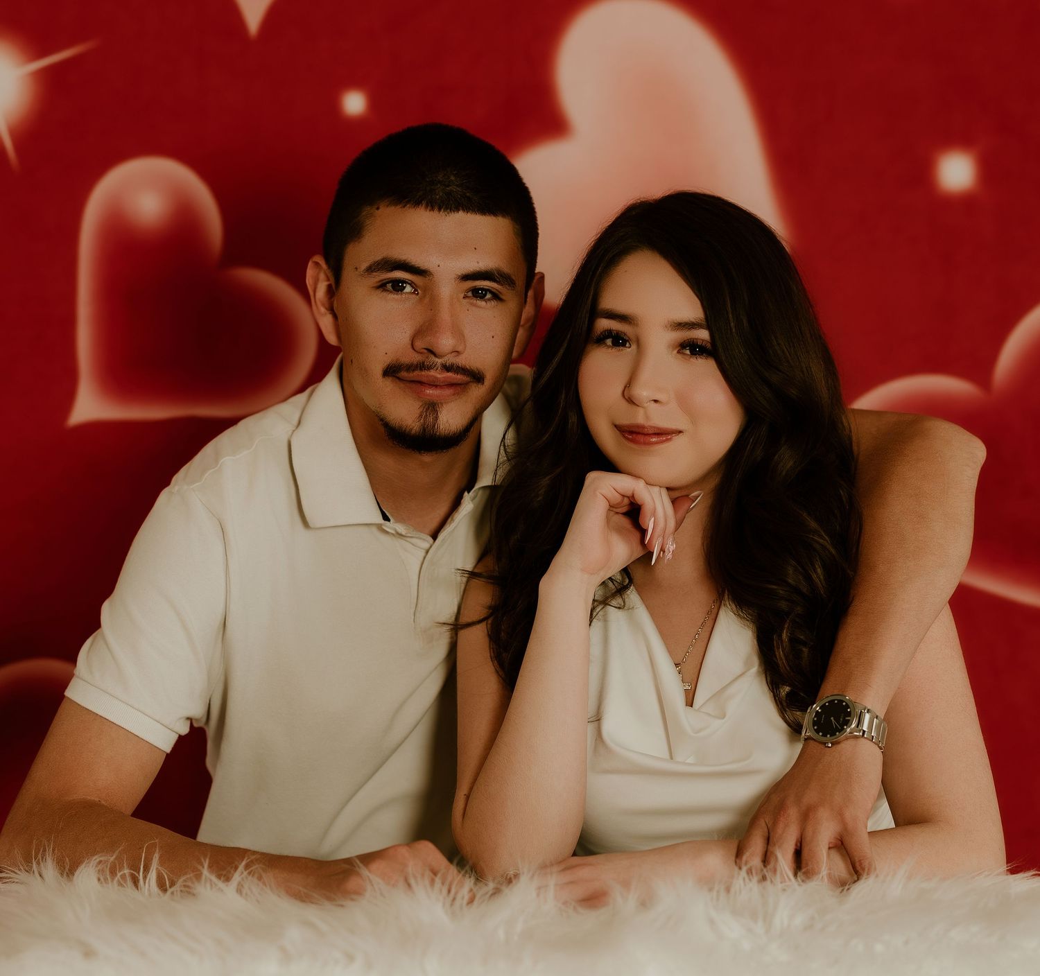 Romantic couple photoshoot with red backdrop showing multiple poses and intimate moments in matching white outfits.
